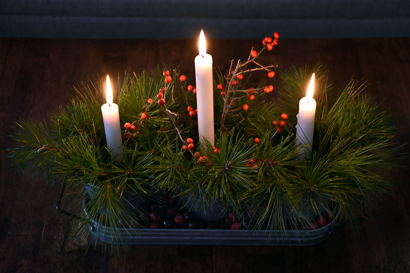 pine branches and cranberries dress up these candles